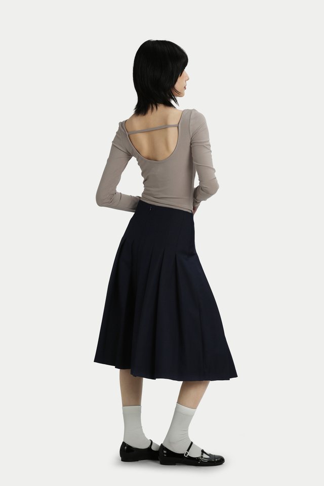 RUMI FRONT BUCKLE PLEATED SKIRT IN MIDNIGHT