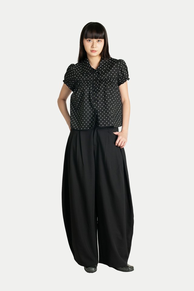 REIKO PLEATED CURVED TROUSERS IN BLACK